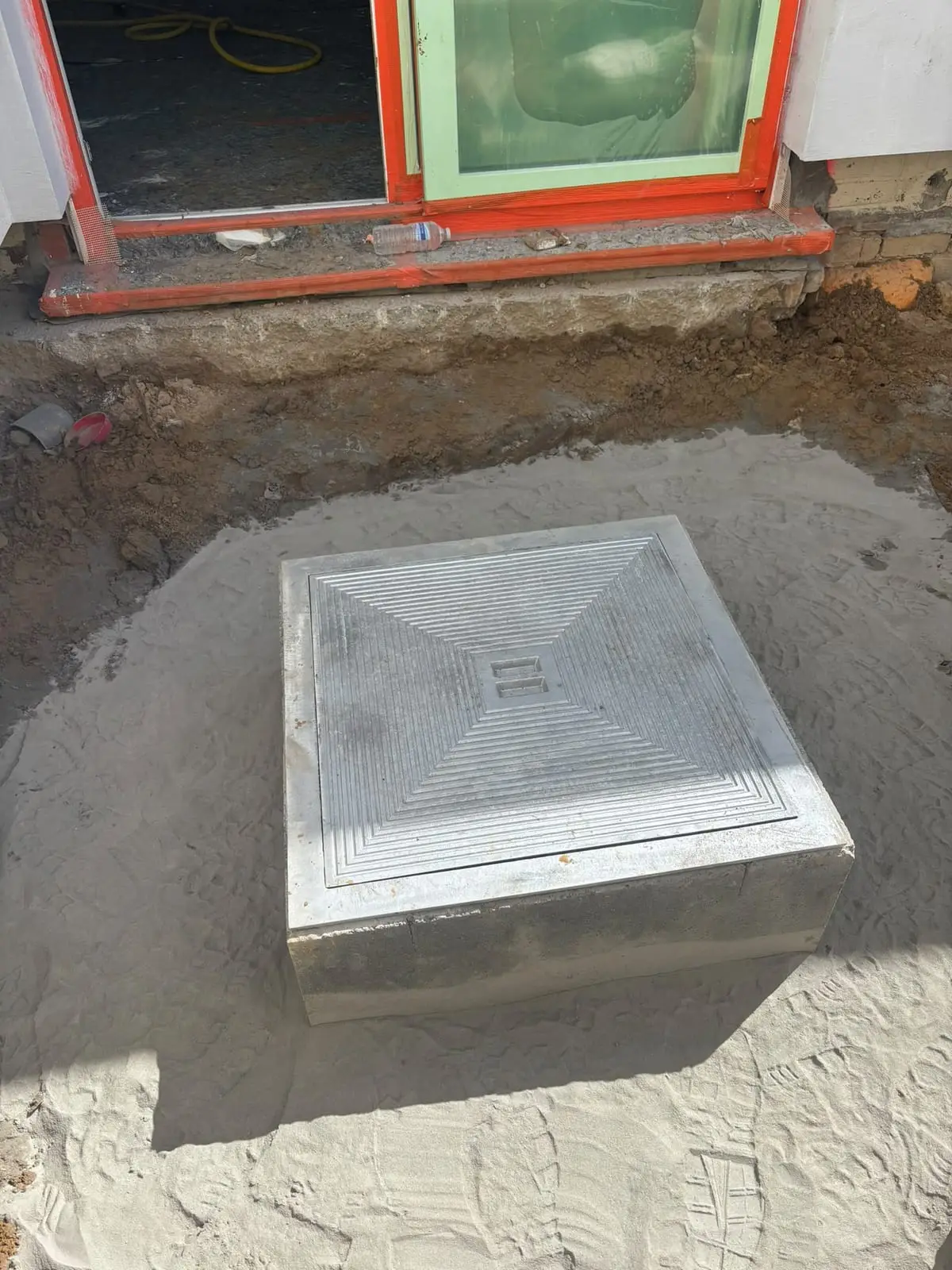 Toezichtsput afgewerkt met deksel voor het raam in Oostakker